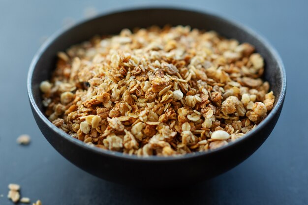 tasty-homemade-fruity-muesli-granola-served-bowl-dark-background-closeup_1220-6262