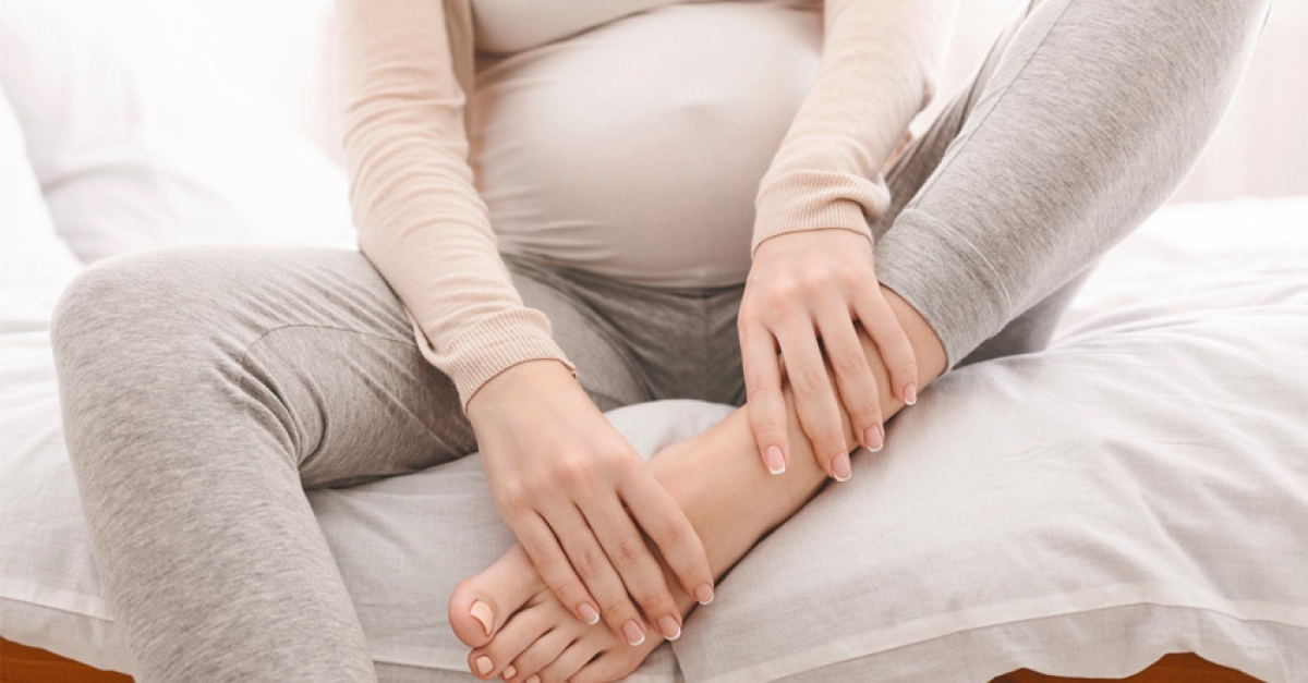 Pregnant-Woman-Holding-Foot-Ankle