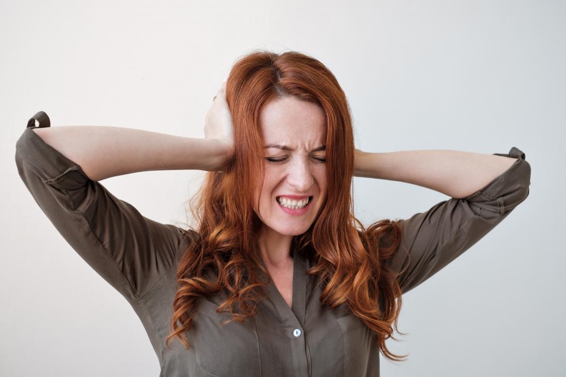 woman_with_misophonia_covering_her_ears_because_she_is_upset_by