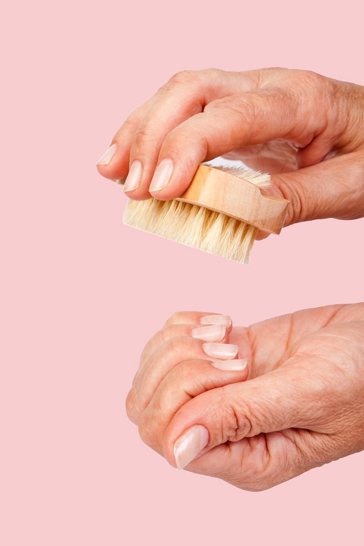 Woman-using-nail-brush-as-part-of-a-hand-care-routine