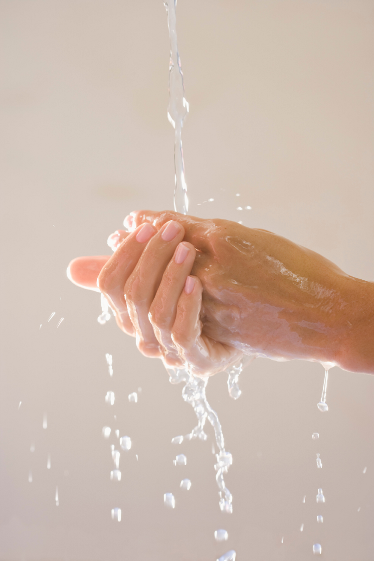 Woman-washing-hands-as-part-of-a-hand-care-routine