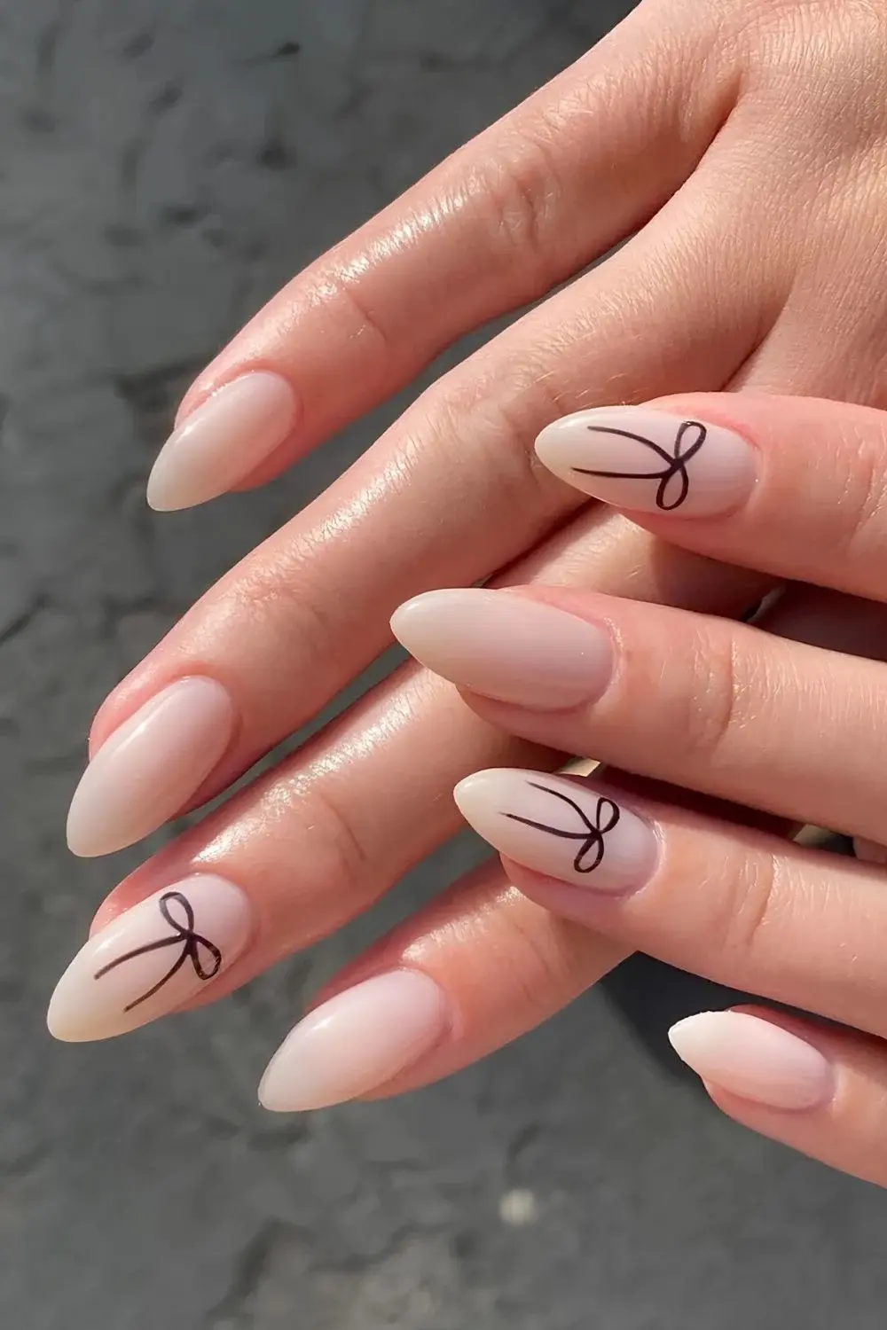 Milky-nails-with-black-bow-accents