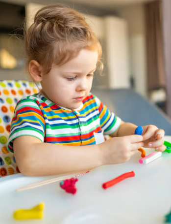 little_girl_plays_with_multicolored_plasticine_creates_different